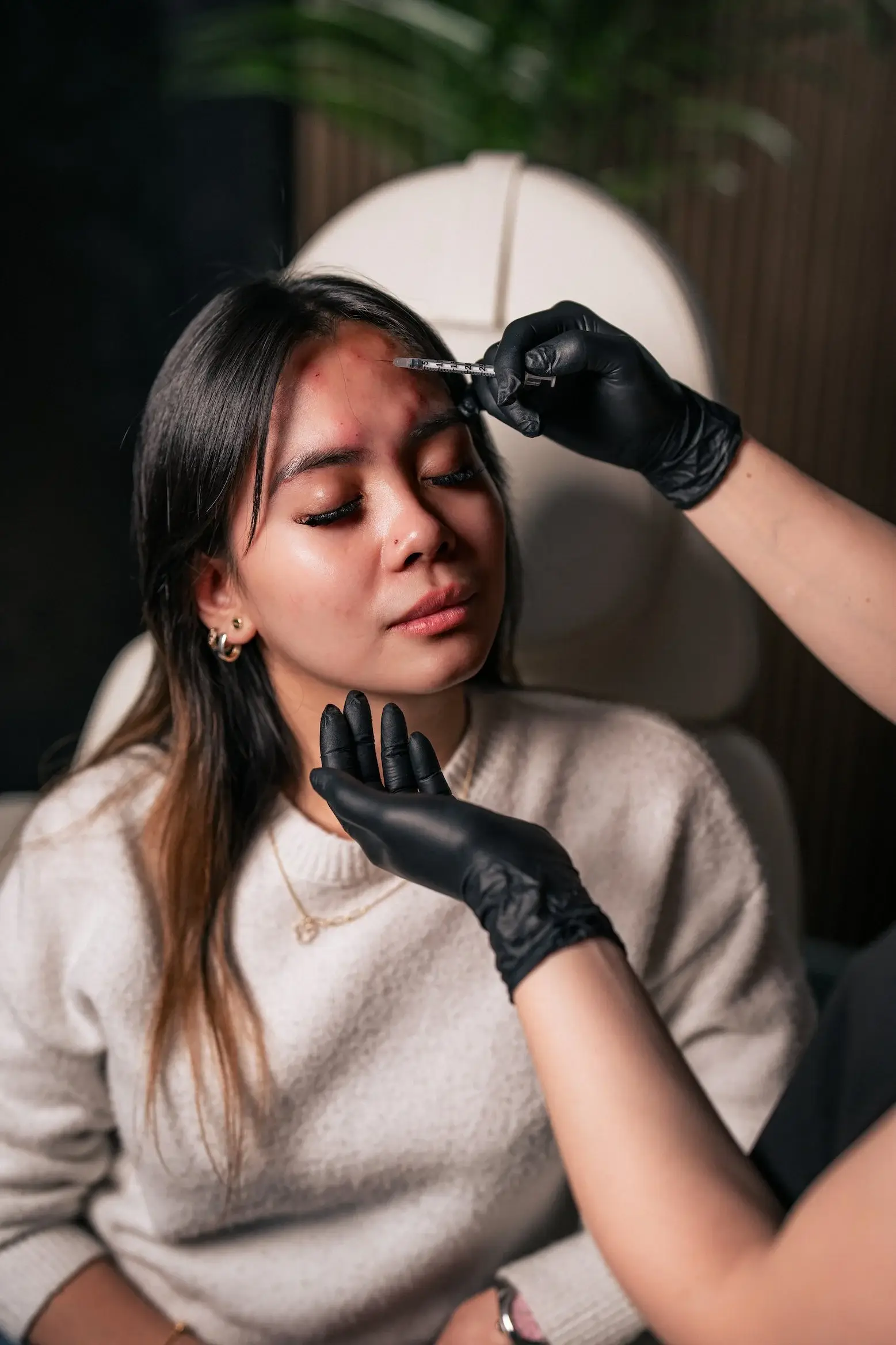Katherine administering a Botox injection to a patient’s forehead in the Glendale studio