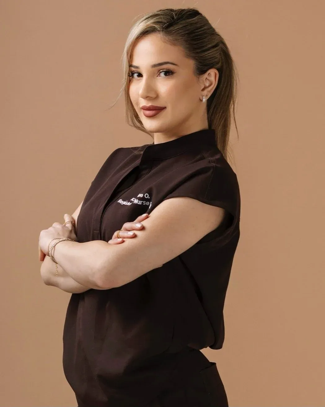 Katherine Oganesyan, RN, in embroidered scrubs at her studio